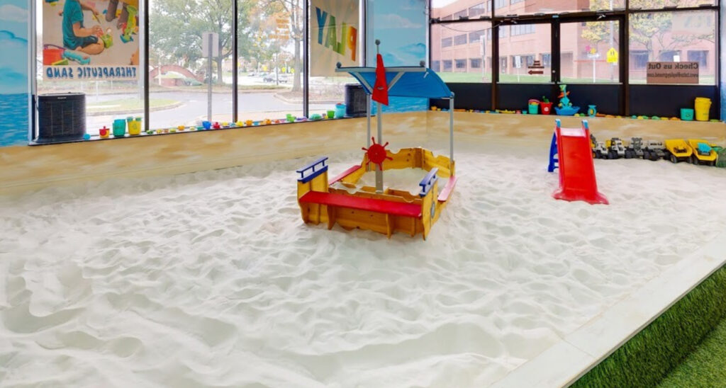 A Sandbox Filled With Sand With Toys To Play